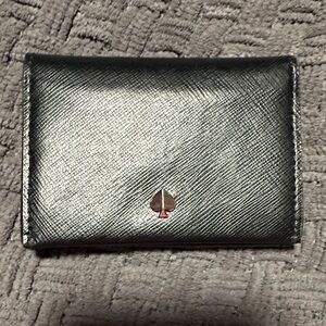 Kate Spade dark blue card holder. Has 2 card holders on each side.